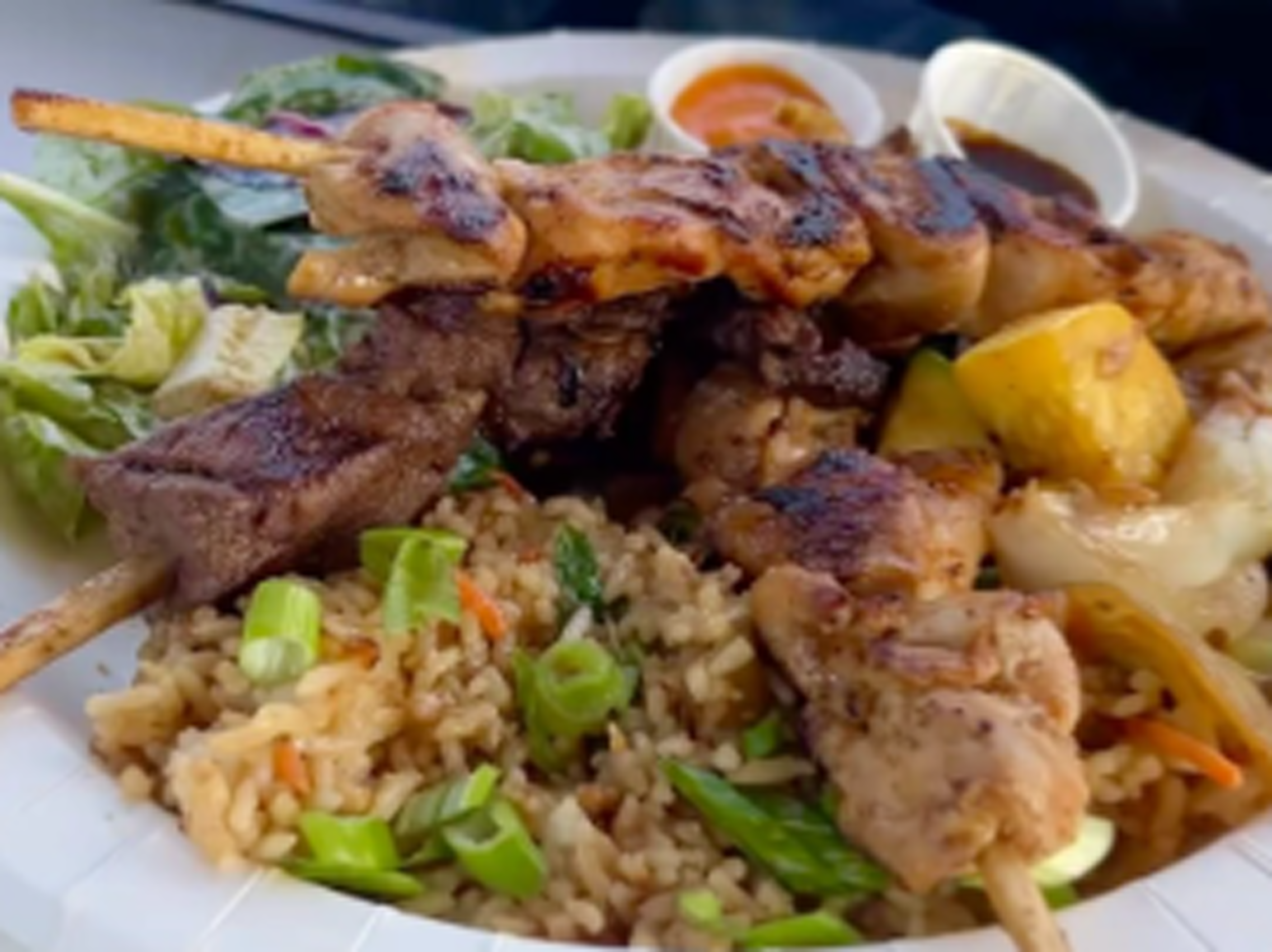 Skewers over rice